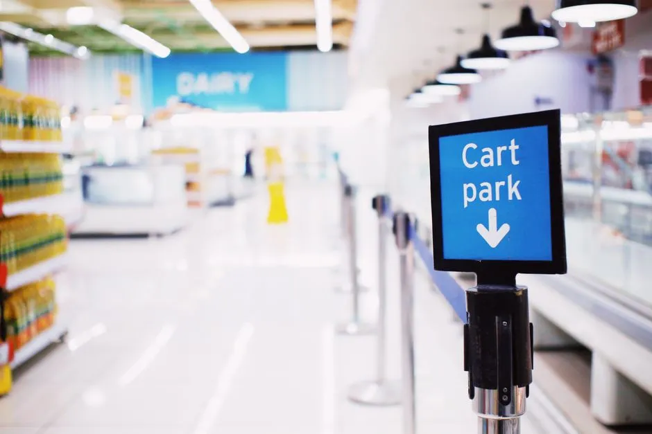 Supermarket aisle interior with overhead department signage